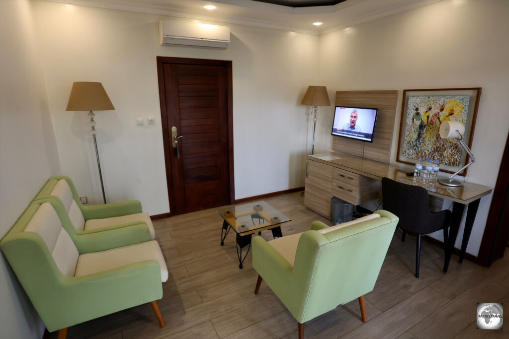 The suite at the Court Boutique Hotel offers a spacious living room and a balcony with views over Kigali.