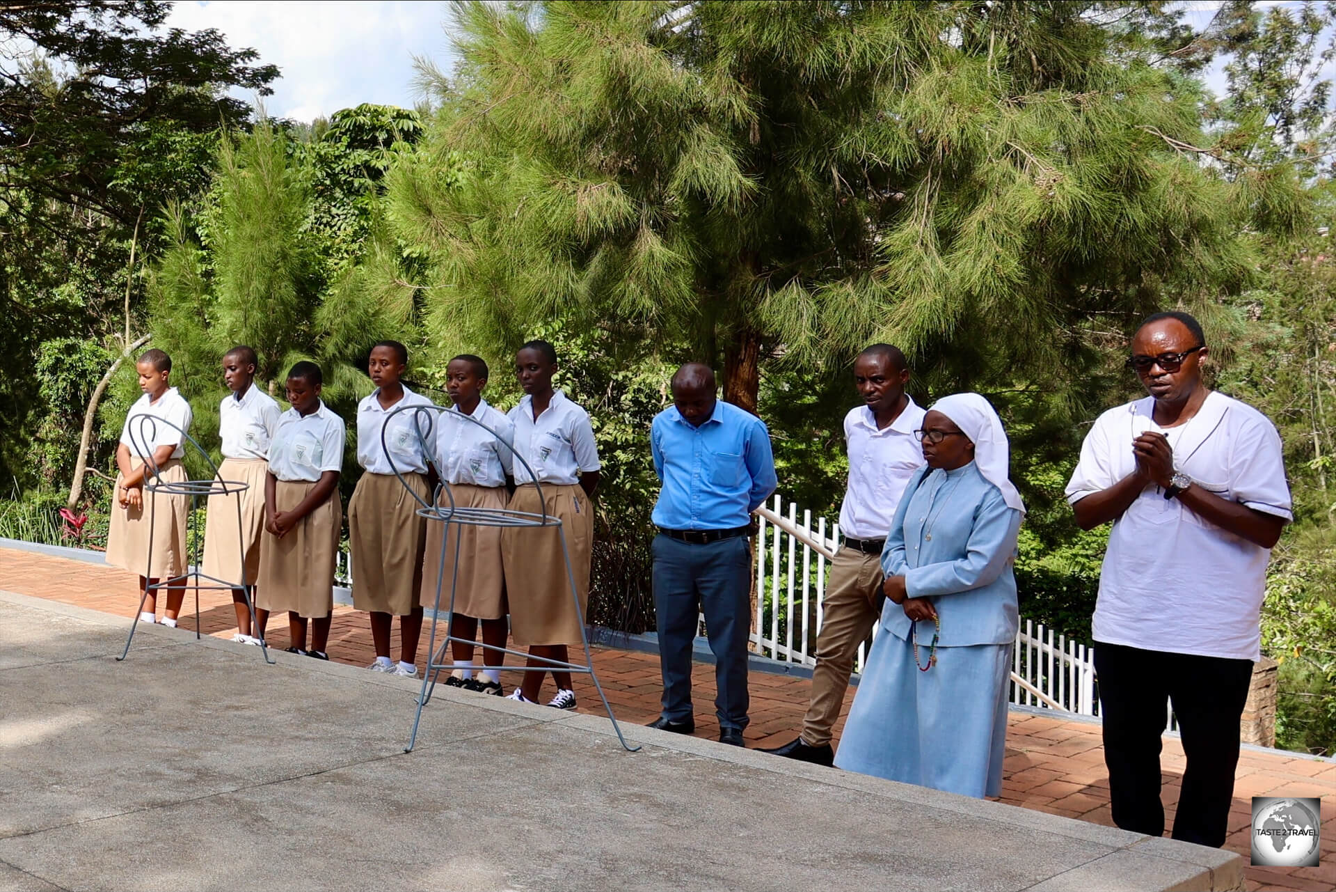 A group of school girls, praying at the Kigali Genocide Memorial.