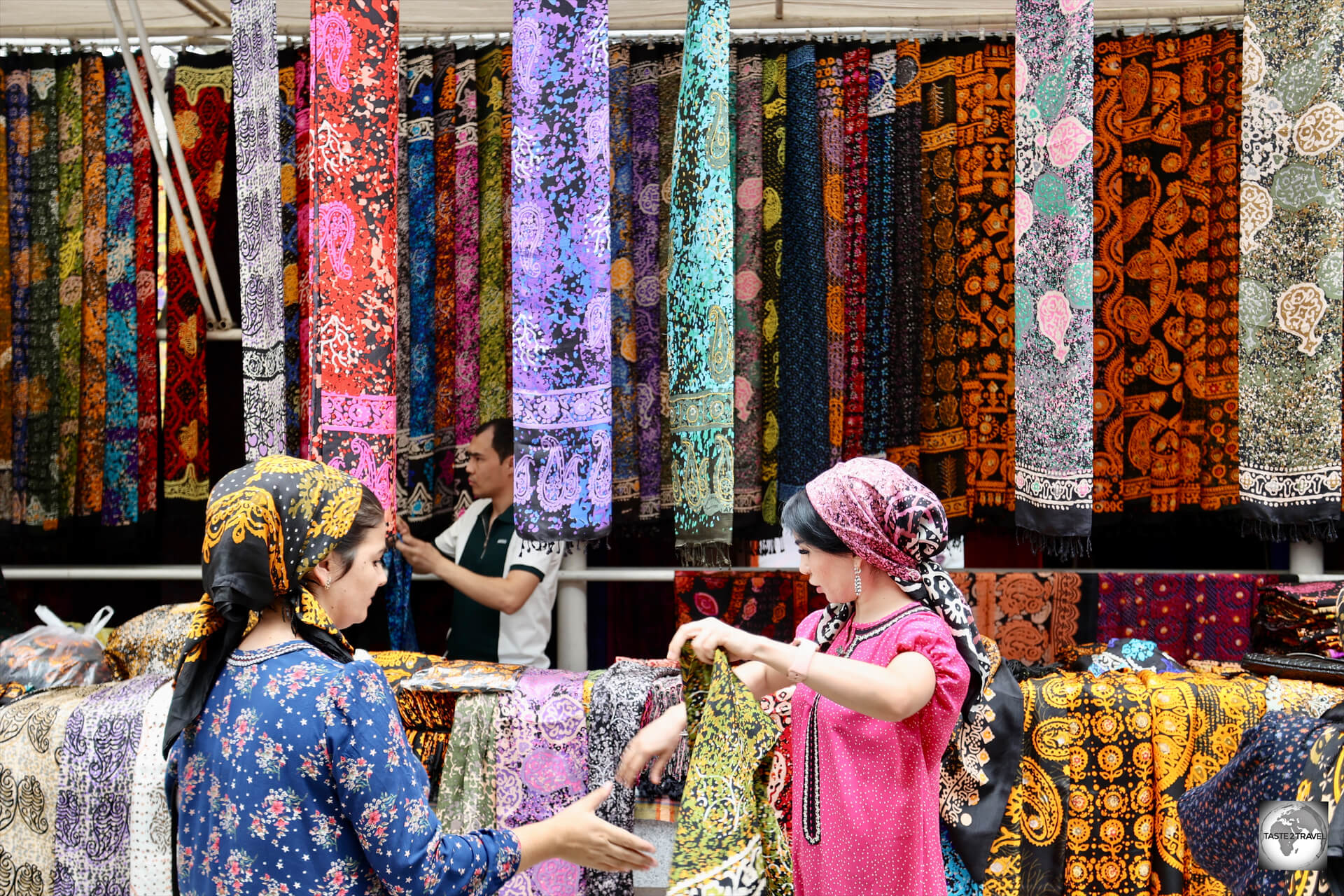 Turkmen women shopping for textiles at the Tolkuchka Bazaar in Ashgabat.