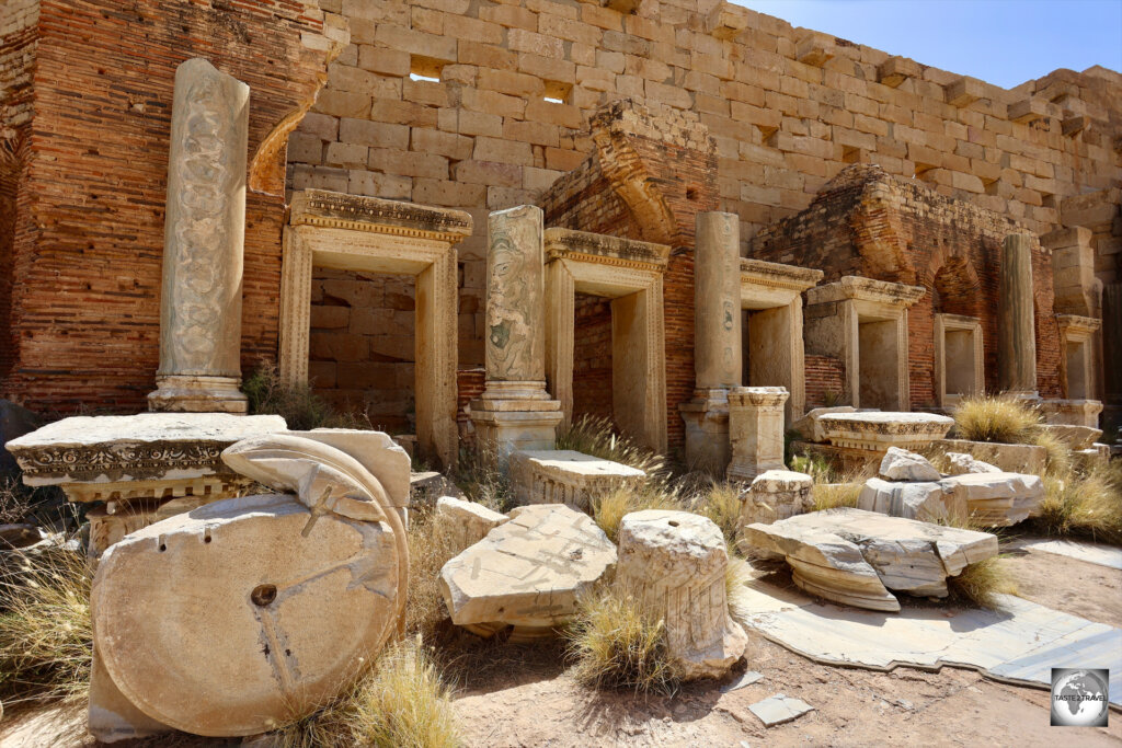 Marble-clad shopfronts line one side of the Severan Forum at Leptis Magna.
