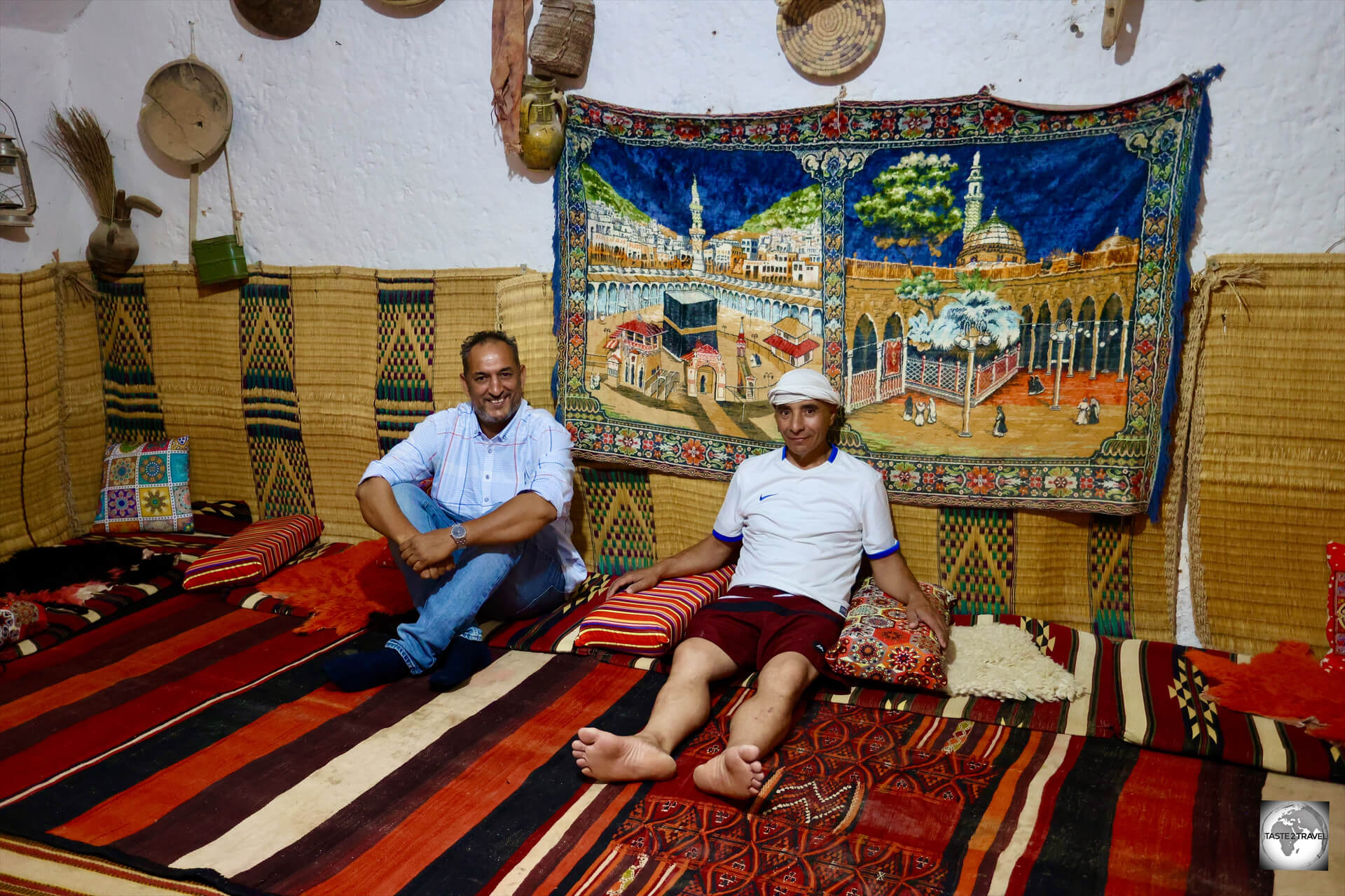 Mr. Al-Arabi Belhaj (right), with my guide, Masoud, escaping from the searing heat outside, in one of the cool underground rooms.
