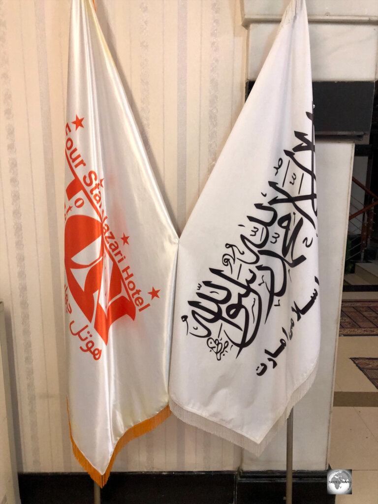 The flag of the Taliban, alongside the flag of my hotel in Herat.