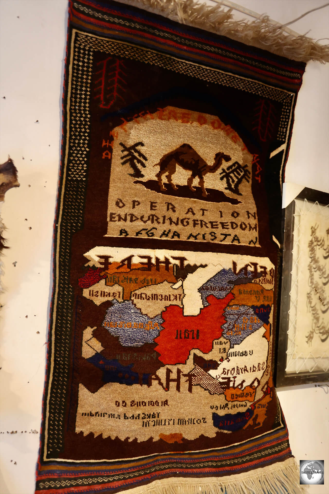 A hand-woven Afghan carpet, commemorating "Operation Enduring Freedom", on sale in a souvenir shop in Herat.