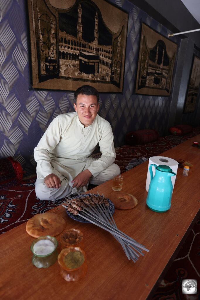 Sharing mutton kebabs for lunch, with my guide, Munir, in Mazar.