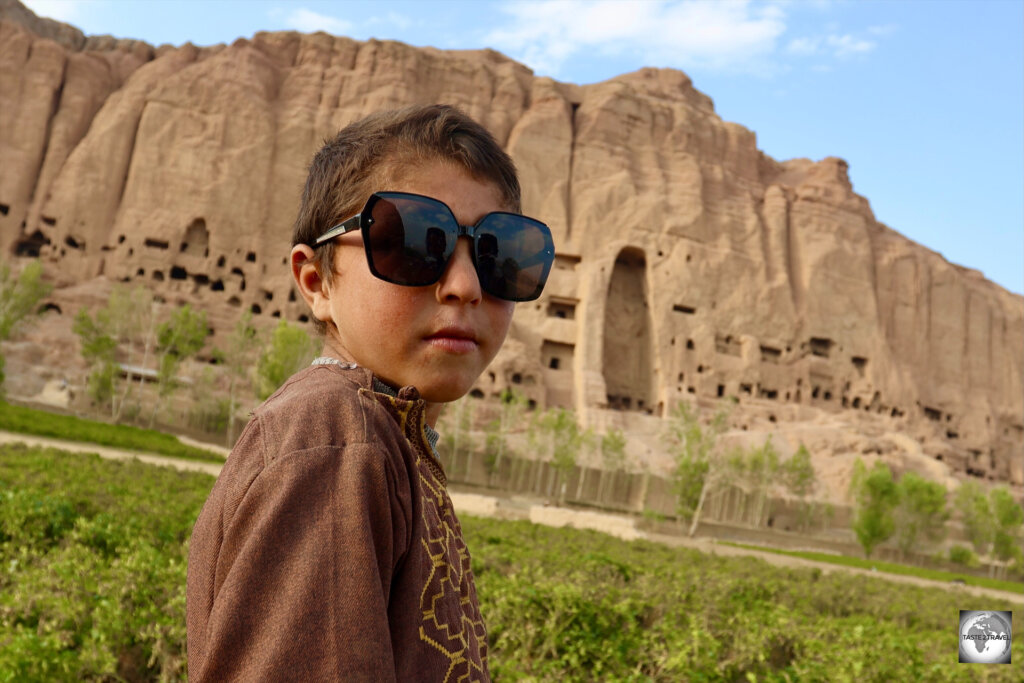 A young Afghan hipster, in front of the Eastern Buddha niche.