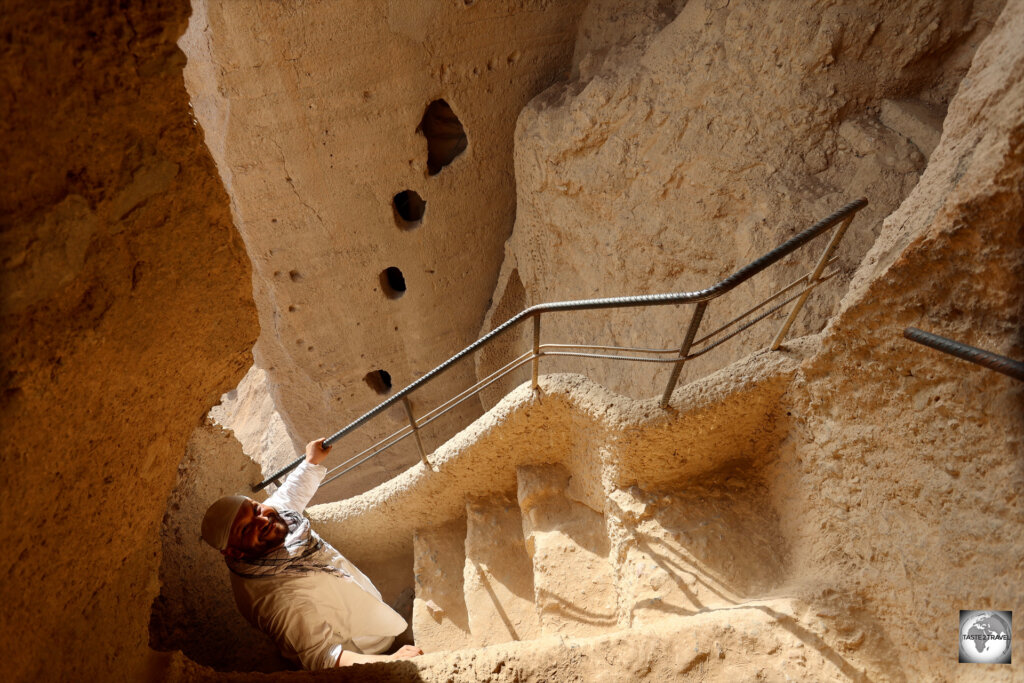 A precipitous staircase, carved into the sides of the cliff, allows visitors to climb up and over the smaller Eastern Buddha.