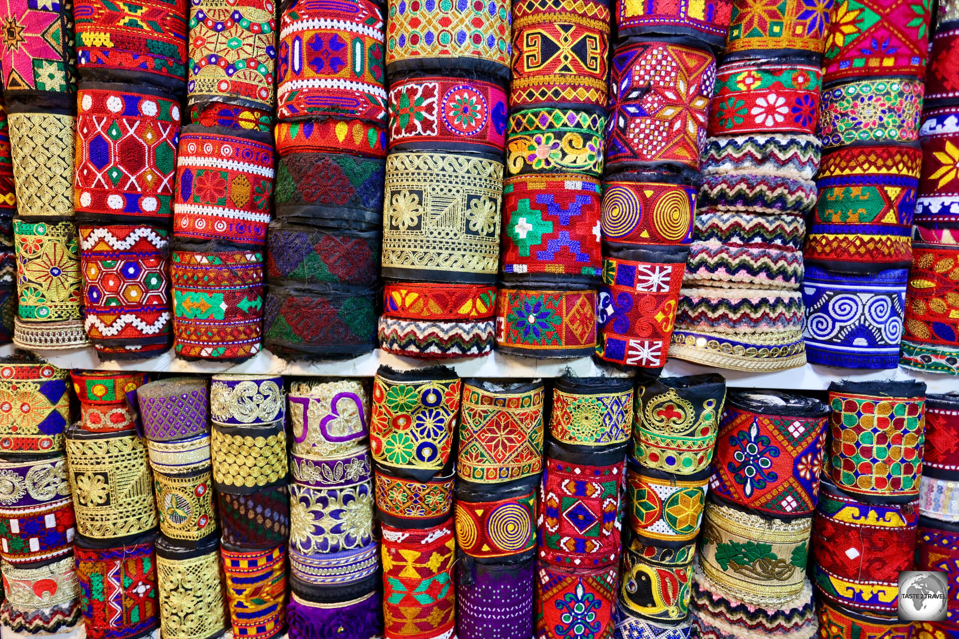 Colourful, hand-woven, rolls of textiles at a shop inside Herat bazaar.