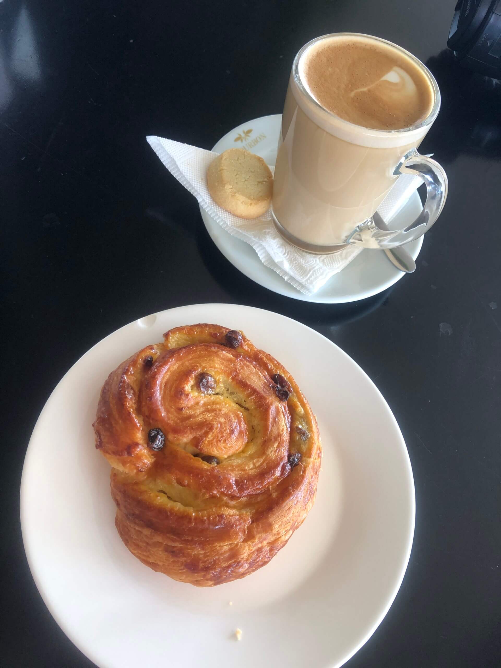 Caffe Latte and a pastry at Bourbon Coffee. in Kigali.